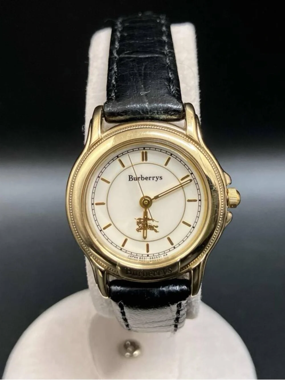 Burberrys Gold Tone Round Watch with Black Leather Strap